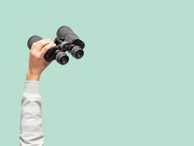 Image of someone holding binoculars